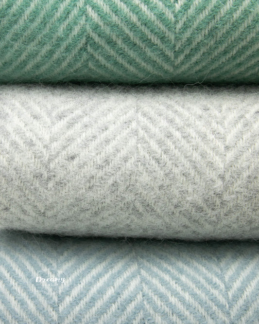 close up shot of wool blankets in teal green, grey, and soft blue hues - dreamylondon