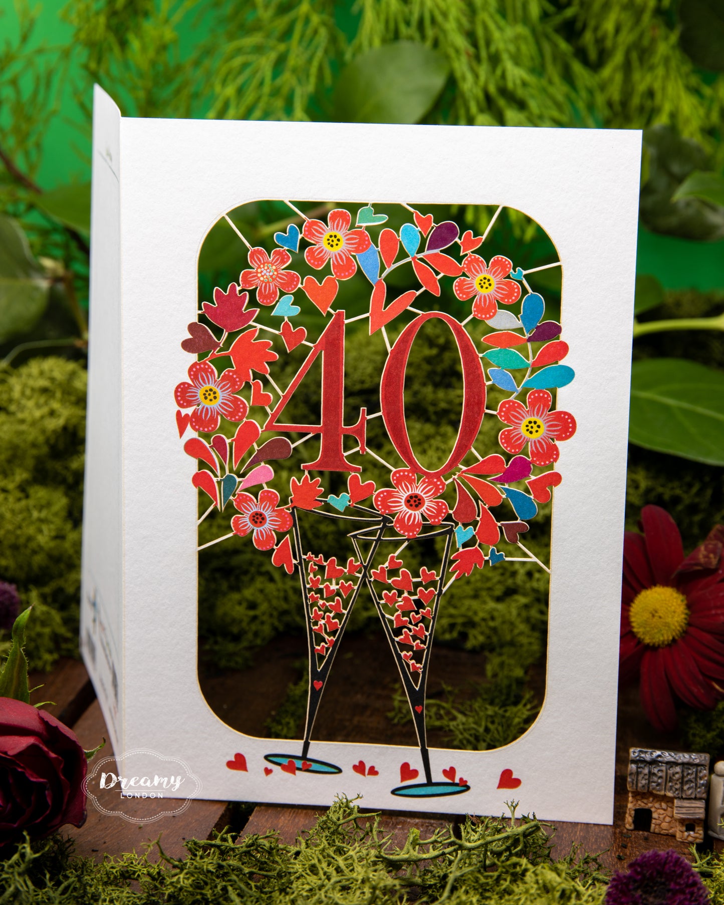 focused shot on the laser-cut design of the 40th Wedding Anniversary Card - Ruby Wedding Anniversary Card that features clanking champagne glasses surrounded with hearts | Dreamy London