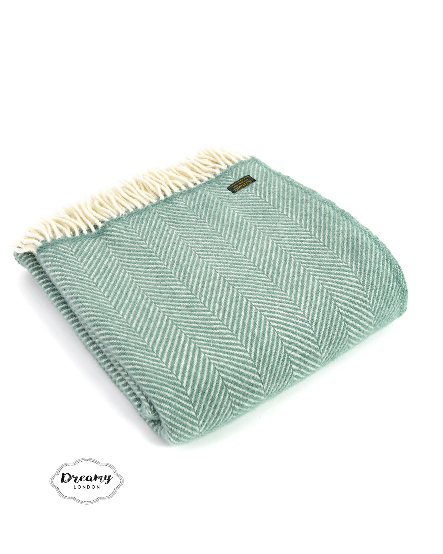 folded wool blanket in teal green with tassels - dreamylondon